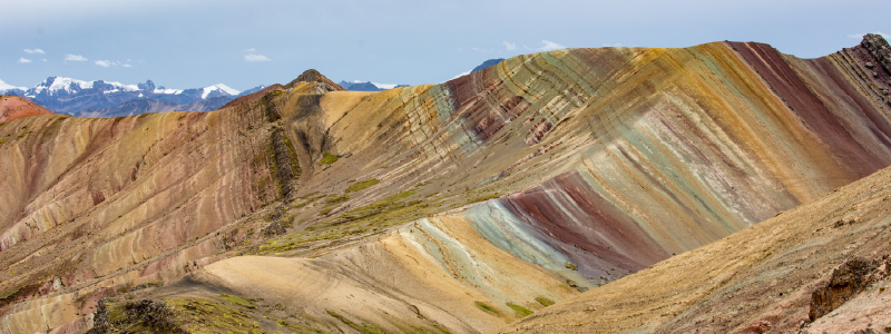 Traveler walking towards Palcoyo rainbow mountains